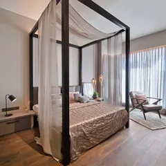 This modern four-poster bed is a great example of minimalist luxury. The clean lines of the dark wood frame create a striking silhouette, while the sheer fabric adds a touch of softness. I can customize the height and style of the posts to fit any room.