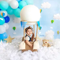 Up, up, and away! The hot air balloon theme creates such a dreamy and magical atmosphere. This little pilot’s happy smile makes my day. These imaginative setups are perfect for capturing your baby's one-year milestone.
