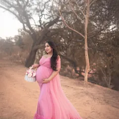 Captured during the golden hour, this outdoor portrait is all about soft, dreamy romance. The flowing pink gown from my client wardrobe and the rustic natural setting create a whimsical, fairytale-like atmosphere, perfect for a romantic maternity photoshoot.