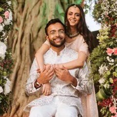 A happy portrait of the newly engaged couple, framed by beautiful floral arches. This shot captures their excitement right after the ring ceremony.