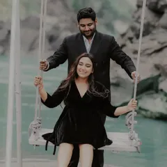 A playful moment on a swing by the water. This photo captures the carefree, joyful side of their relationship, showing that love is also about having fun and being kids at heart together.