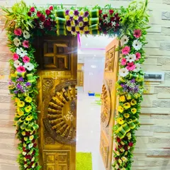 The celebration begins at the front door. Here is an example of a lush floral arch I designed for a home entrance, using a mix of fresh greenery and colorful flowers to welcome guests and Bappa into the home.