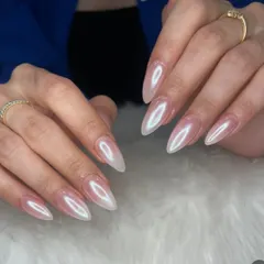 My forever favorite, the holochrome finish. These long, stiletto-shaped nails have a pearlescent, almost-white chrome effect that reflects a rainbow of colors in the light.