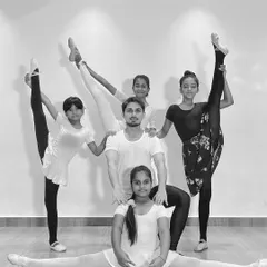 My advanced ballet students showcasing their flexibility and strength in a group pose. This demonstrates the results of dedicated training and practice in my classes.