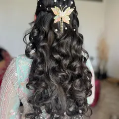 Hair stories. A half-up, half-down style with soft curls and a beautiful butterfly accessory.