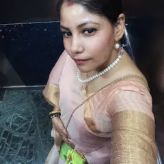 An elegant elevator selfie capturing the festive spirit. This soft pink organza saree, paired with a classic pearl necklace, is a testament to timeless grace, perfect for celebrating Durga Puja.