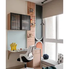 This compact study nook is perfect for a growing mind. The terrazzo-topped desk adds a pop of texture, echoing the room's palette of rust, green, and grey. A playful pegboard above is both fun and functional.