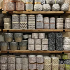I love this shelf display. It shows the variety of gorgeous planters I have for both indoor and outdoor use, with a focus on pots that feature pops of color, texture, and geometric patterns.