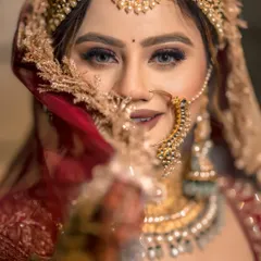 A bride's portrait is more than a picture; it's a story of her grace and strength. We use creative lighting and composition to capture the soul behind the smile, as seen in this striking close-up of our bride Gurbani, her eyes telling a story of dreams and devotion.