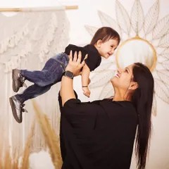 A mother's loving gaze as she lifts her child high. These candid, interactive shots result in the most genuine smiles and create beautiful, emotion-filled family portraits.