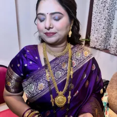 The complete guest makeup look in a traditional purple saree. The eyes are softly smoked, and the skin is given a healthy, luminous finish.