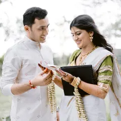 The groom presents his bride with a custom-made photobook tracing their love story. Her smile shows the beautiful surprise and emotion of the moment.