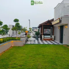 Another view of the New Friends Colony project, highlighting the checkered patio area and the seamless integration of green space and hardscaping.