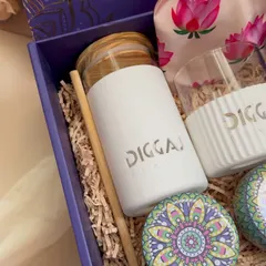 A close-up of the branded borosilicate sipper and glass for Diggaj Realty. The logo is cleanly integrated, making it a premium piece of merchandise that employees will be proud to use.