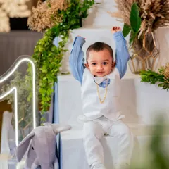 Look at this dapper little gentleman celebrating his big day. We love capturing the unique personality of every child, whether they are shy, energetic, or the star of the show. This portrait highlights the beautiful decor and the birthday boy's adorable outfit.