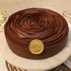 Our Belgian Dark Chocolate Gateaux, elegantly finished with a rose swirl. We use high-quality chocolate crafted in Belgium for a rich, bittersweet flavor and smooth texture.