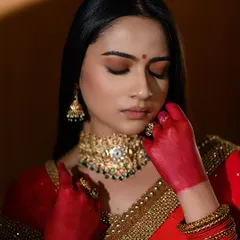 A close-up from our conceptual red saree shoot. The hands stained with red alta add a traditional and symbolic layer to this modern portrait.