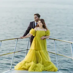 Create your own fairytale moment with a photoshoot on a yacht. This couple showcases our vibrant yellow tiered gown, a perfect choice for a pre-wedding shoot that is both romantic and unforgettable. I help you get these amazing shots with my collection of statement gowns.