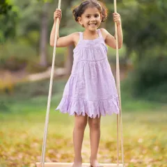 A magical swing session in nature. The combination of golden light, a simple swing, and a happy child creates a perfect portrait of innocence and joy.