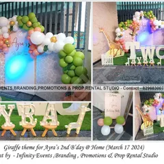 A cute giraffe theme for a second birthday at home. The decor features a "TWO" table, giraffe cutouts, and a lovely balloon arrangement in shades of green, white, and peach.