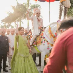 The sister of the groom leads the baraat with joy and energy. We styled her in a vibrant lime green lehenga that was perfect for a day wedding, allowing her to dance freely and celebrate.