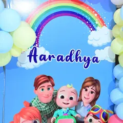 A close-up of the Cocomelon backdrop, featuring the whole family under a rainbow.