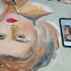 Watch a student bring a portrait to life with acrylics. This work-in-progress shows the process of layering colors from a photo reference to build up skin tones and facial features on canvas.