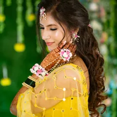 A candid moment of the bride admiring her intricate floral haath phool and mehndi. I love capturing these quiet, personal moments amidst the joyful chaos of the Haldi ceremony.