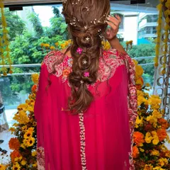 A whimsical and romantic braided hairstyle, perfect for a fun Mehendi or Haldi ceremony. I wove in delicate star and pearl accessories with pops of pink flowers to match the bride's vibrant outfit.