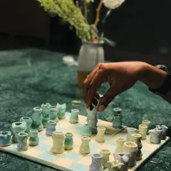 Yes, you can even make your own chess set. We call this one 'Cocoa Clash,' a charming, hand-glazed set crafted right here in our studio. It’s a reminder that art can be playful.