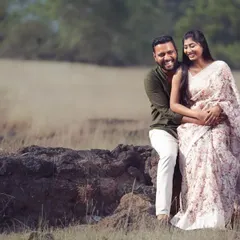 A happy, candid moment during a pre-wedding shoot in a rustic, grassy field. I encourage couples to relax and be themselves, which results in natural and joyful photos like this one.