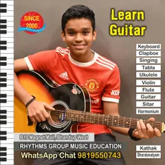 A young student learning to play the acoustic guitar. Our classes for children are designed to be engaging and fun, building a strong musical foundation from an early age.
