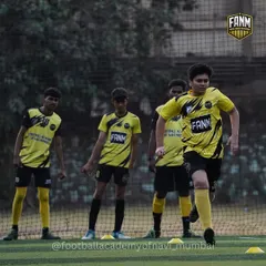 A team of players jogs together, showing the unity and shared purpose that I foster in my academy.