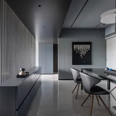 A walk through the dining space in 'A Hint of Azul'. A long, curving, and slatted partition separates the dining area from the living room, allowing natural light to filter through while maintaining a sense of distinct zones.
