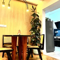 A tall Ficus Elastica, or Rubber Plant, is a fantastic way to add vertical interest to a room. Here, it fits perfectly into a dining corner, drawing the eye upward and complementing the warm wood tones.