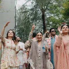 The baraat party arriving with full energy and dancing. We capture the fun and festive mood of the wedding procession against the lush greenery of the beach resort.