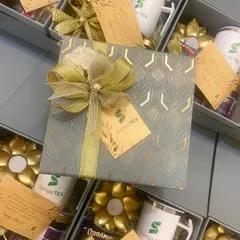 Our absolute bestseller for corporate Diwali gifting. This elegant grey box for Symps TEX includes a customized mug, gourmet treats, and a lotus tea light holder.