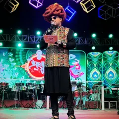 A full stage view during a Navratri performance. You can see the professional setup with a live band and a massive drum kit, all part of creating an unforgettable Garba night experience.