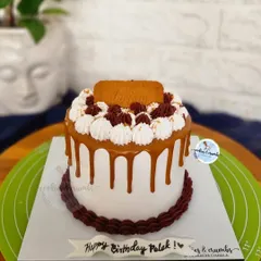 A delicious Lotus Biscoff Mousse Cake. This 650g cake is topped with a creamy Biscoff drip, whipped cream swirls, and a signature Lotus biscuit.