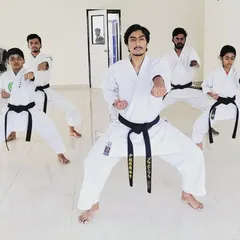 I lead from the front. Here, I am with my senior black belt students, practicing our stances. Discipline is everything in my dojo.