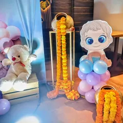 A close-up of the props from the fusion-style baby shower, showing the mix of modern cartoon cutouts, teddy bears, and traditional floral elements.