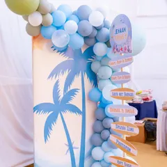 A custom directional signpost points guests to the different fun zones of the party, like the 'Arts N' Krafts' corner, 'Splash Zone', and 'Photobooth'. It's a fun and practical decor element.