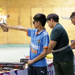 A coach's guidance can make all the difference. Here, I am working with a student on his air pistol form during a training session, helping him make the small adjustments that lead to big improvements.