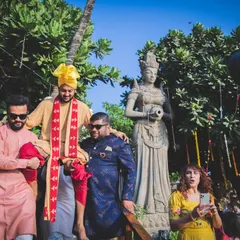 The groom being carried by his friends, a fun and chaotic moment during the baraat. We capture the energy and excitement of the groom's procession.