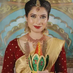 This is the quintessential South Indian Muhurtham look, radiating elegance and tradition. I focused on creating a flawless base, classic winged eyeliner, and a timeless red lip to complement the beautiful gold and red tones of the bride's attire.