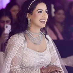 A candid moment of laughter. The makeup, with its silver glitter and sharp details, stayed flawless throughout the celebrations.
