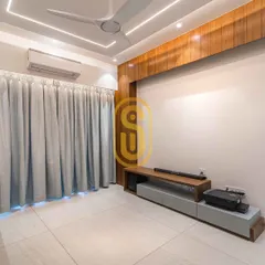 A minimalist TV unit designed for a clean and uncluttered look. The wooden paneling on the wall adds warmth, while the low-profile console provides essential storage without overwhelming the space.