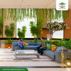 We transform large interior spaces, such as this corporate lobby, into vibrant atriums. The design uses multi-level planting with tall bamboo stalks, flowering trees, and cascading hanging plants to create a natural canopy over a central seating area, improving air quality and fostering a sense of tranquility.