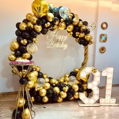 This black and gold themed 31st birthday is the definition of chic. We created a full circle balloon frame, added a custom neon "Happy Birthday" sign, and included large marquee numbers to create a glamorous photo-op for the celebration.