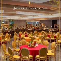 An expansive view of a large-scale event space we catered. The vibrant tablecloths and organized seating around our extensive buffet lines demonstrate our capability to manage grand gatherings with flair and efficiency.